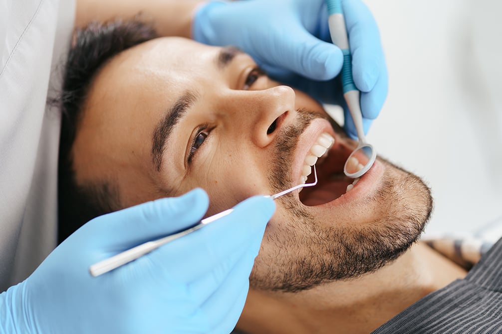 Smiling young man sitting in dentist chair