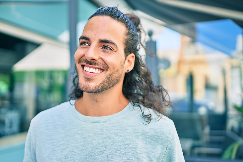 Young hispanic man smiling